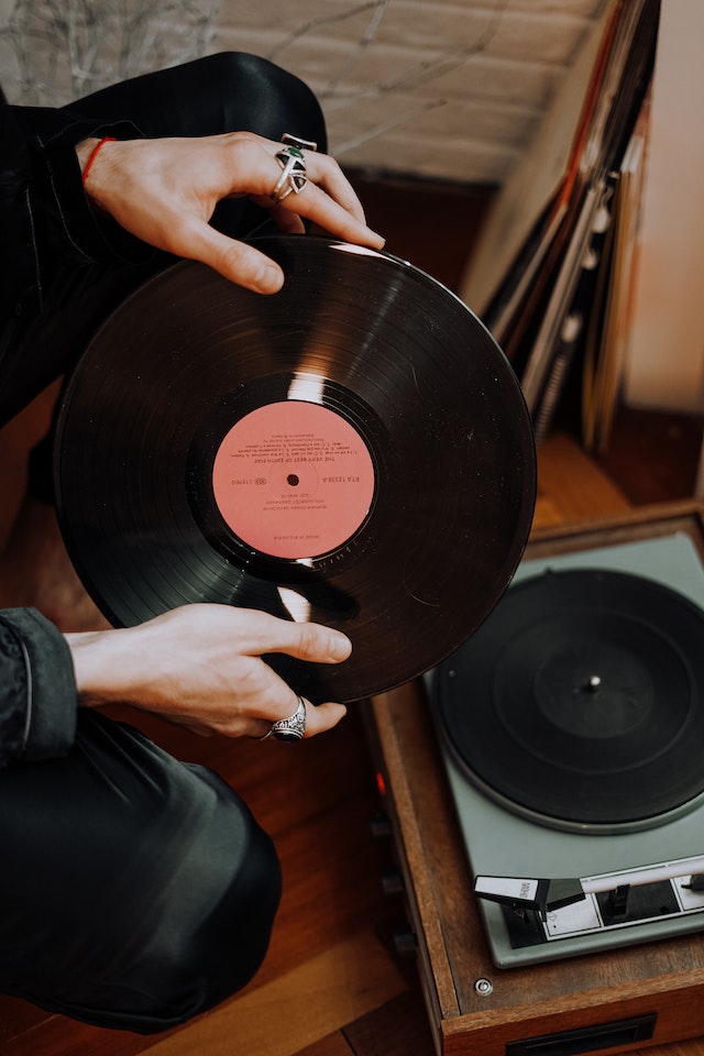 woman holding a vinyl from her favorite artist