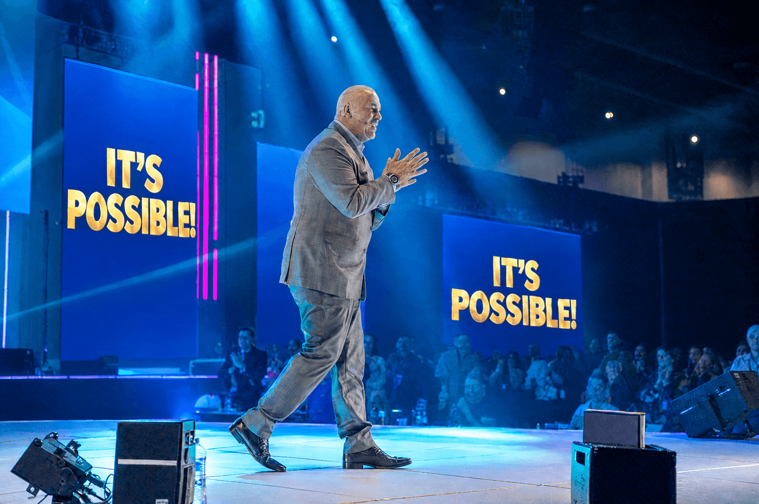 Shane Morand on stage in front of a large audience: It's possible