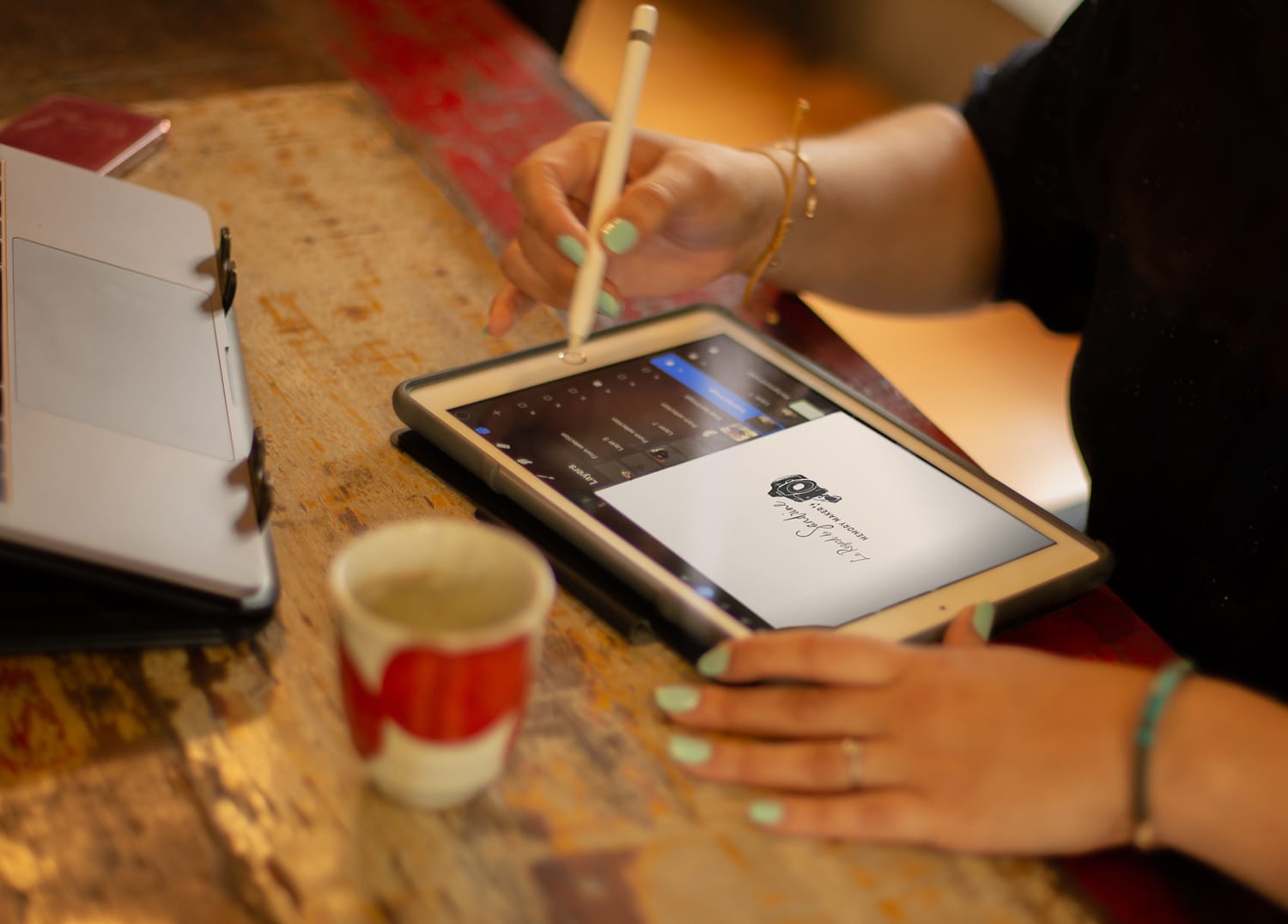 Maria drawing a personalised logo design on iPad with Apple pencil Maria Phieros, Creative Director of AM Studio Créatif, award-winning brand designer