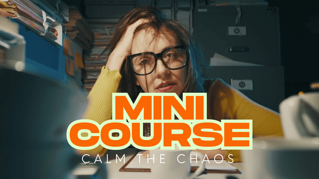 mini-course, calm the chaos by laugh to feel good. we see an image of a stressed person a their desk with piles of work