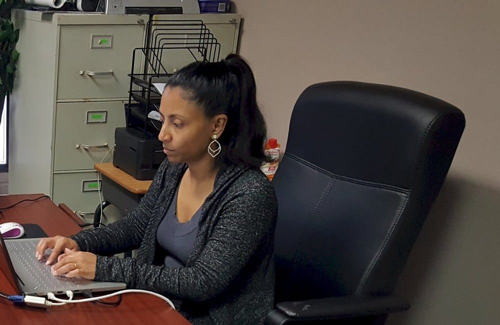 Loma Risper working at her desk