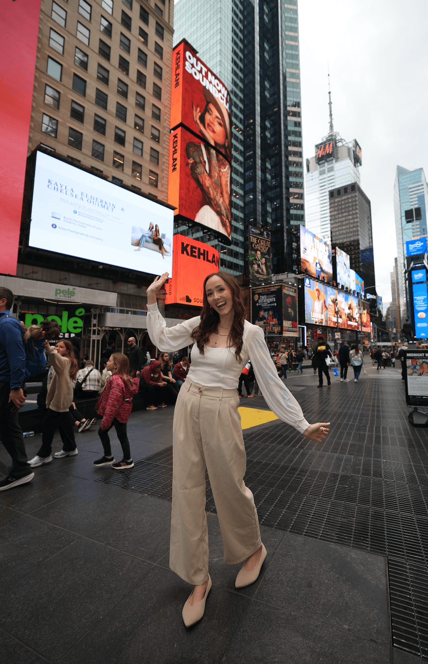 Kayla Elderkin in Times Square beneath her billboard