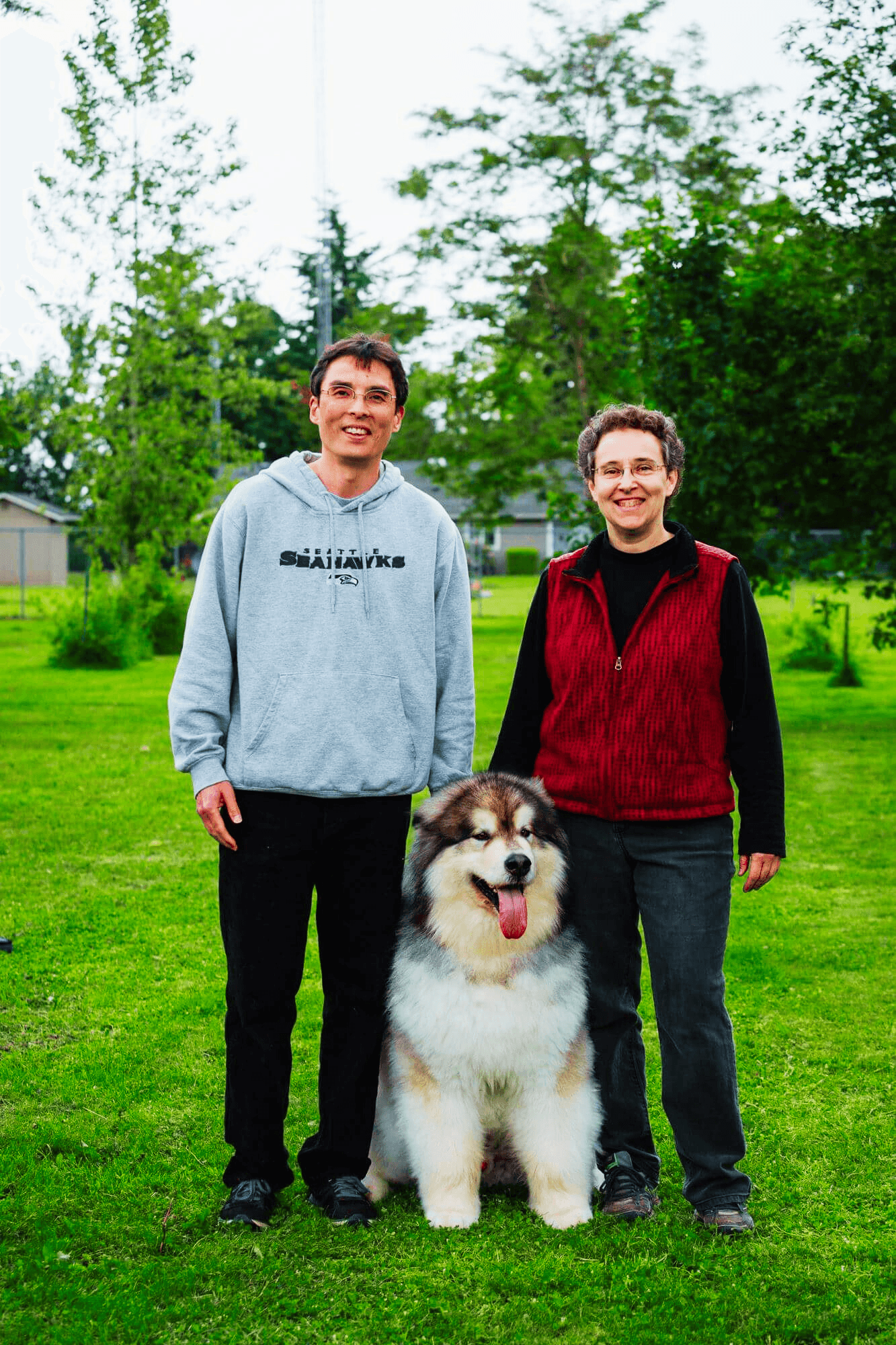 Peter, Lisa and their dog standing outside smiling