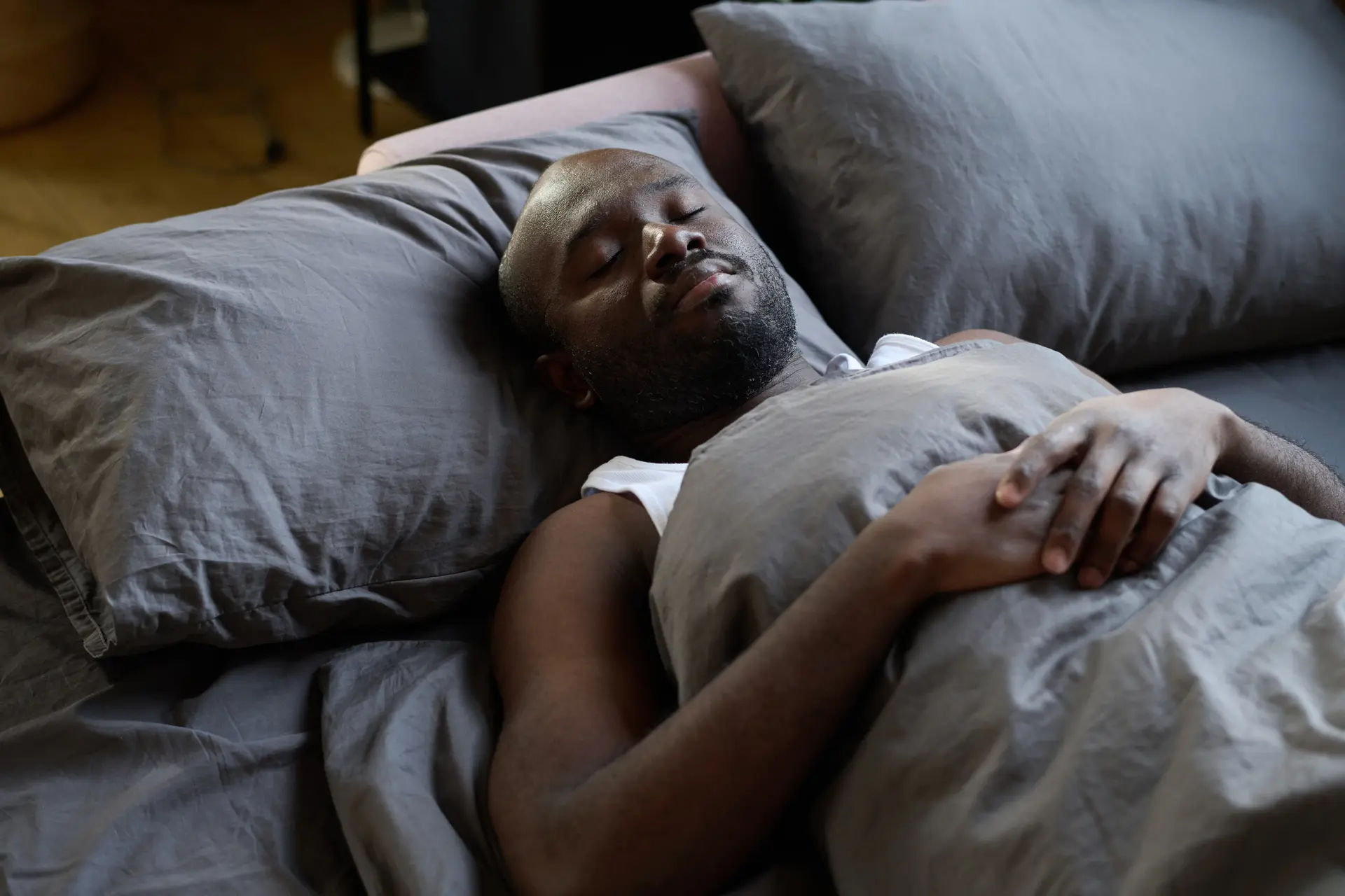 Man resting in bed after sleep hypnosis