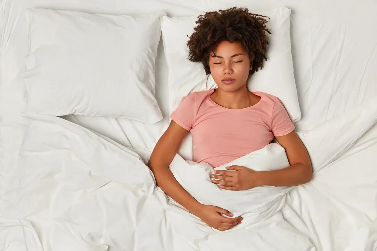 Woman asleep in bed after sleep hypnotherapy