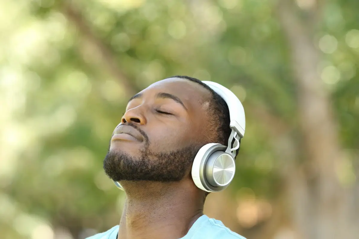 Man listening to online course with headlphones
