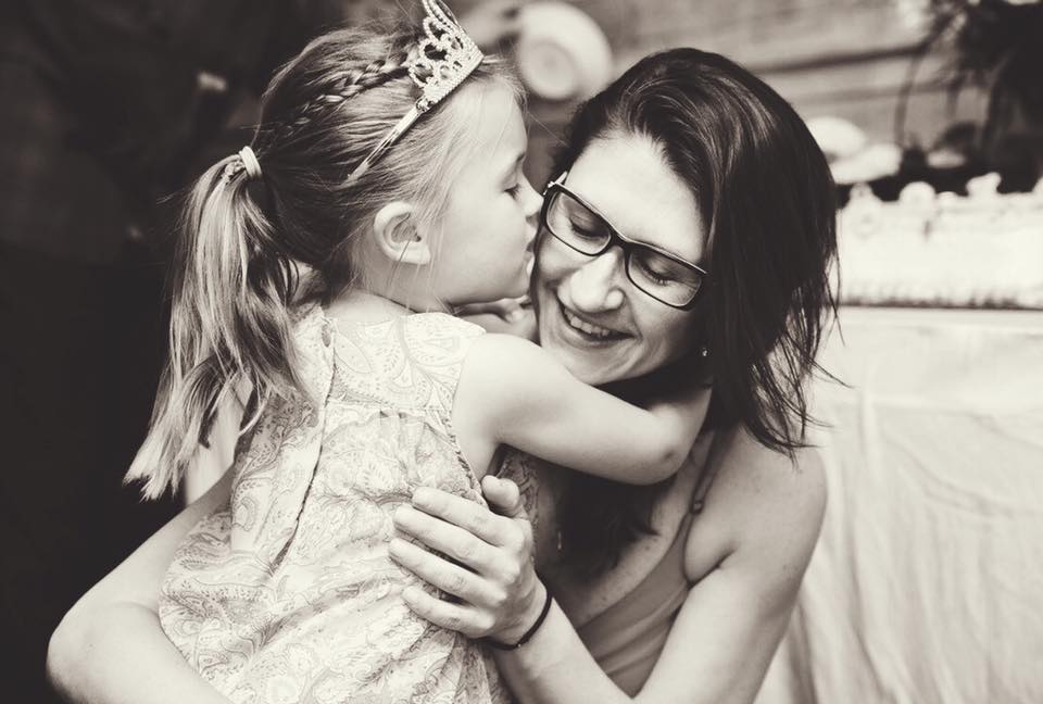 a little girl hugging her mom