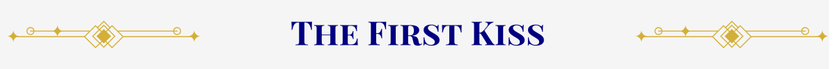 Section Header: Basic banner with a pearl-white ground. In the center, in navy, are the words, “The First Kiss” that are sandwiched between gold art-deco elements.