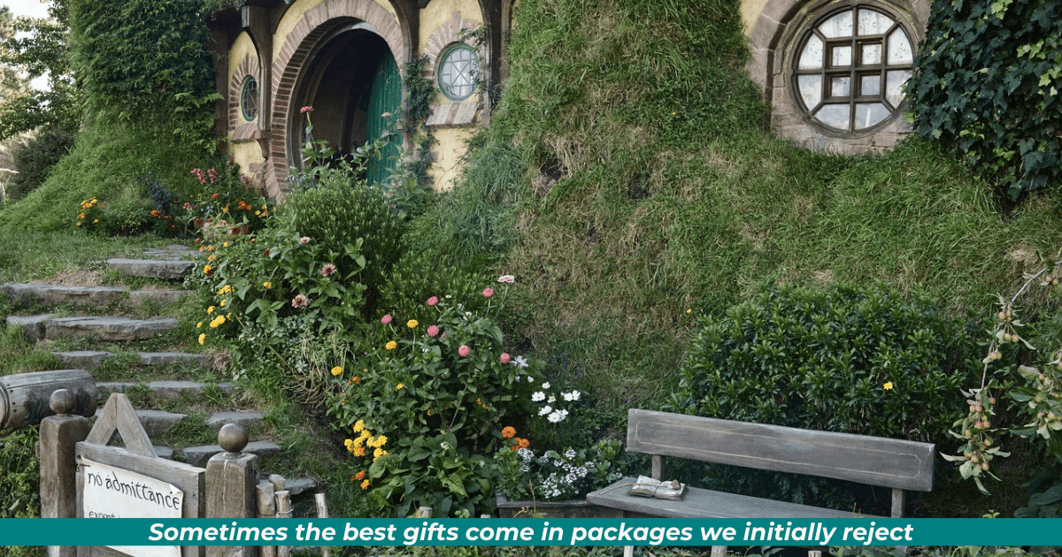 Scene from The Hobbit movie: Bilbo's front yard complete with bench, porthole window, teal front door and sidelights, and the famous (or would that be infamous?) "No Admittance" gate sign that Frodo nails up.