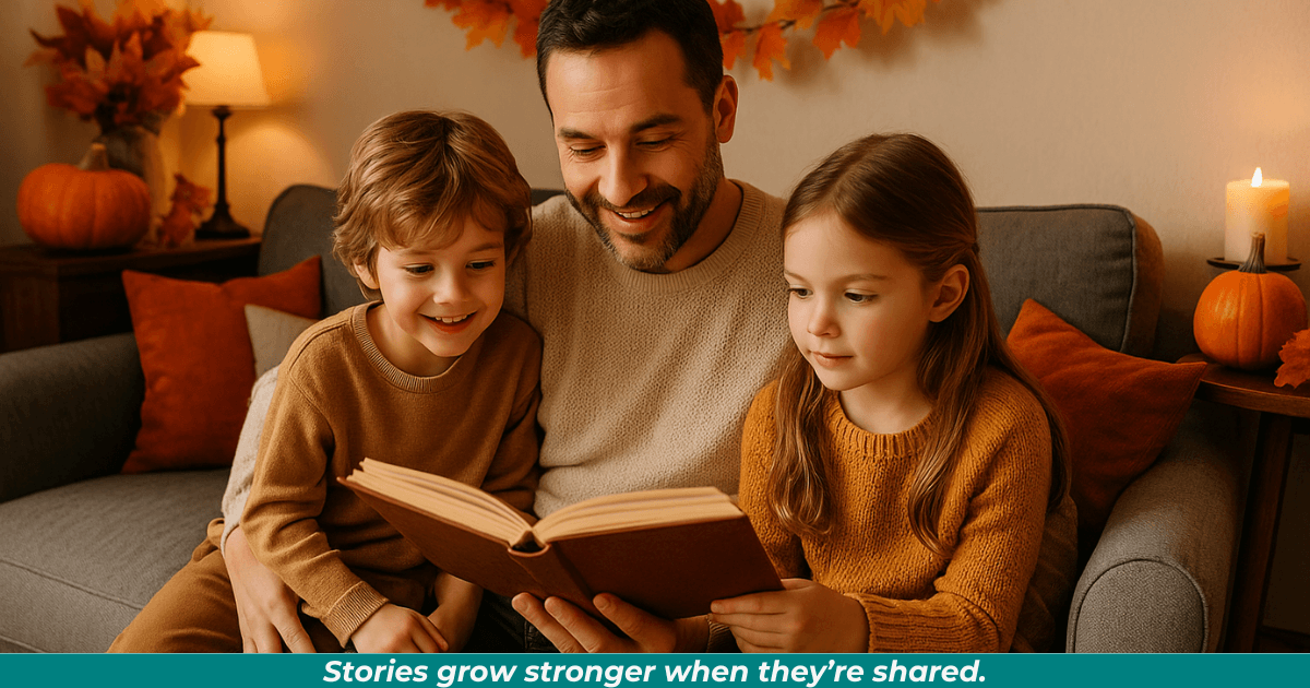 A father reading aloud with his son and daughter. They're sitting on a gray sofa in a cozy living room, decorated for fall with a maple-leaf wreath, candles, and pumpkins.