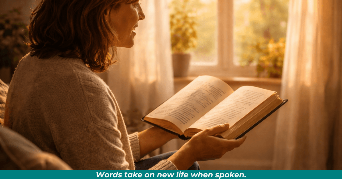 A person reading aloud in natural light, celebrating shared reading.