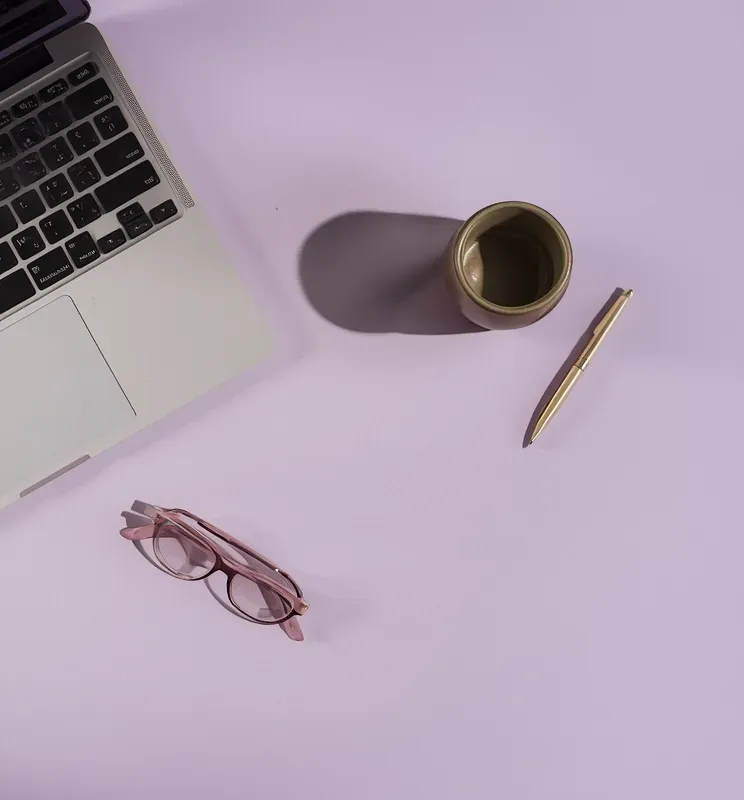 Laptop and coffee on a desk.