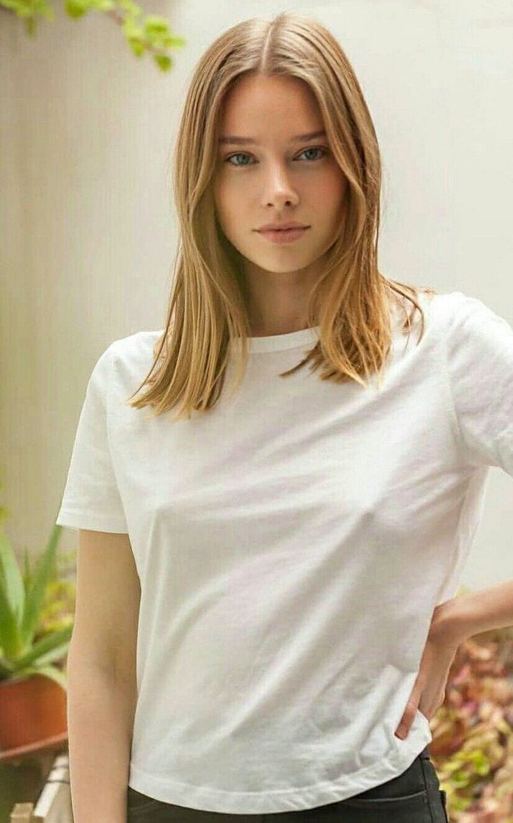 beautiful blonde girl in white t shirt confident look nipples protruding small breast blue eyes