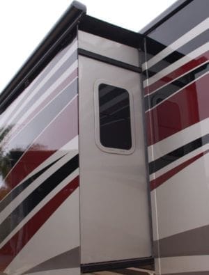 Repairing RV slide-out seals on a travel trailer at a campground.