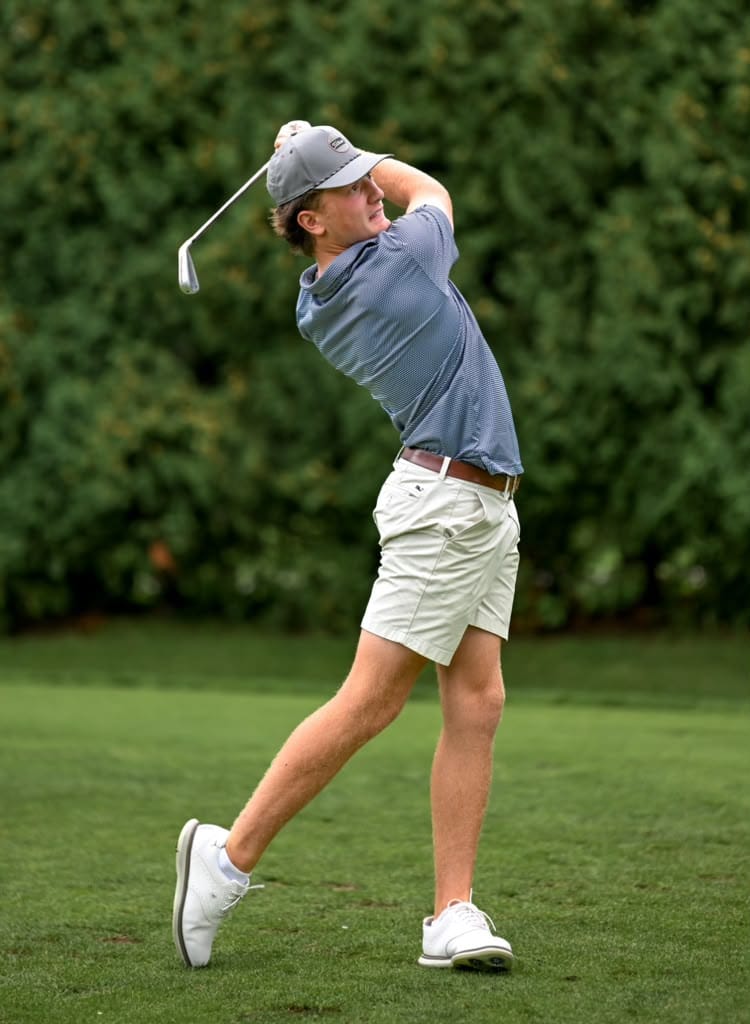 Junior golfer following through on a golf shot