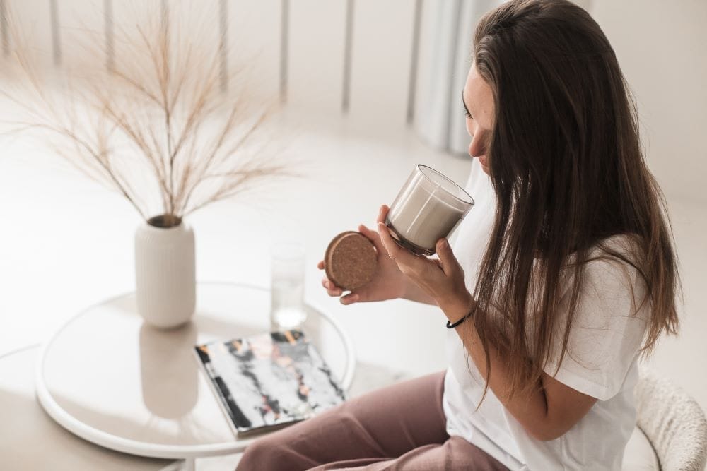 women enjoying a scented candle