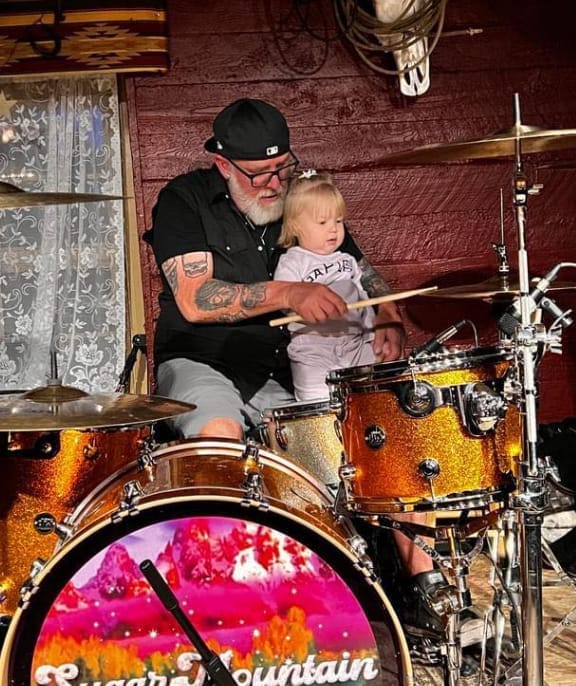 Sammy P. a Professional drummer at his kit with his granddaughter.