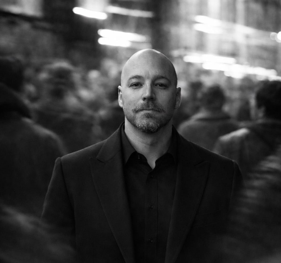 Dan from No Jargon AI standing at a whiteboard, explaining artificial intelligence concepts to a small group of business owners.