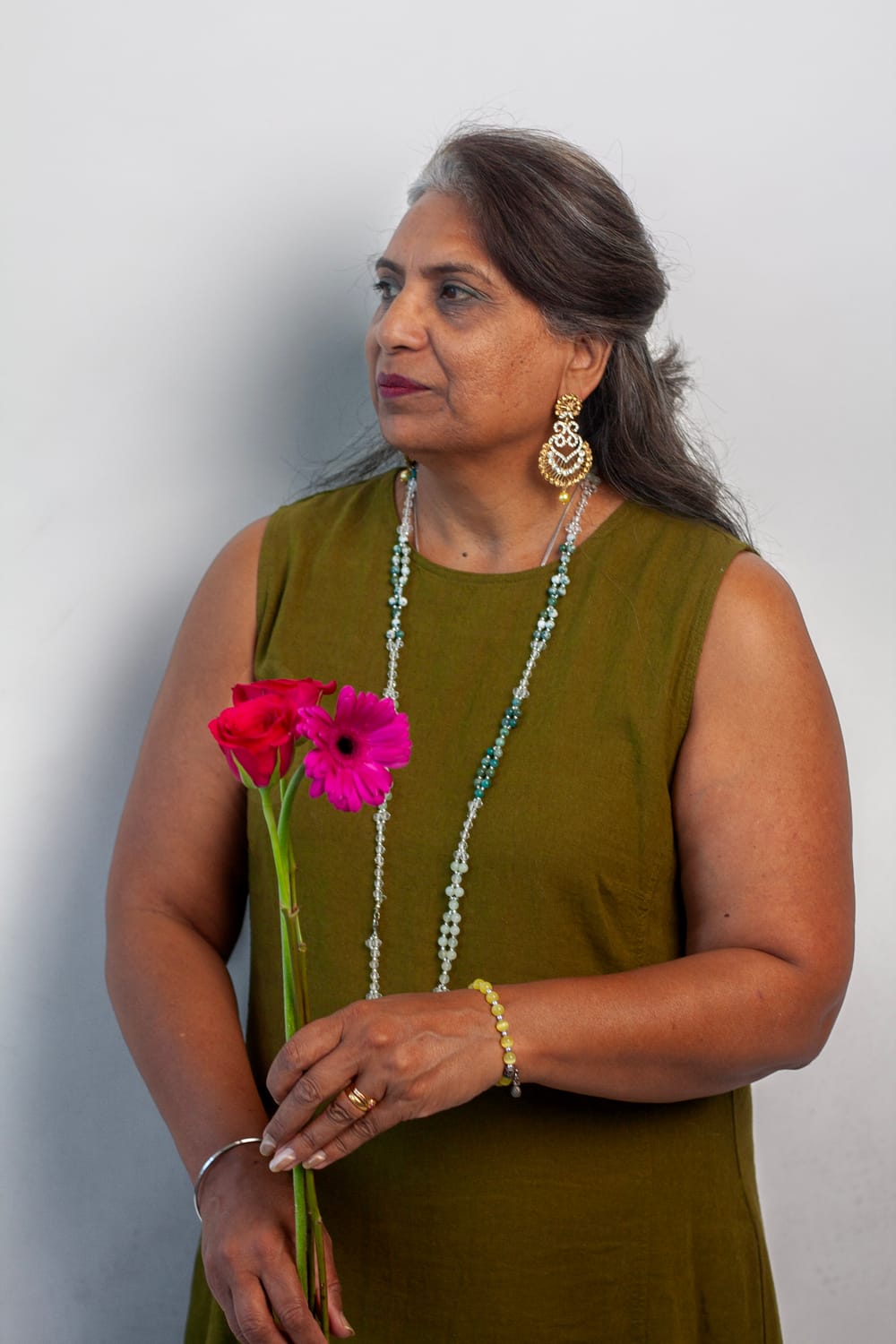 Harjit Khondhu standing outdoors with flowers