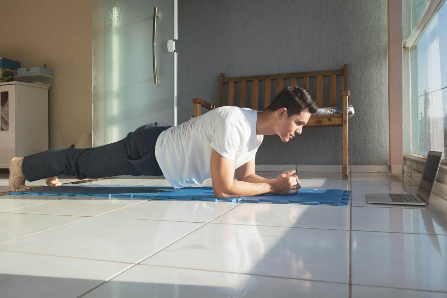 imagine cu un barbat care efectueaza plank acasa