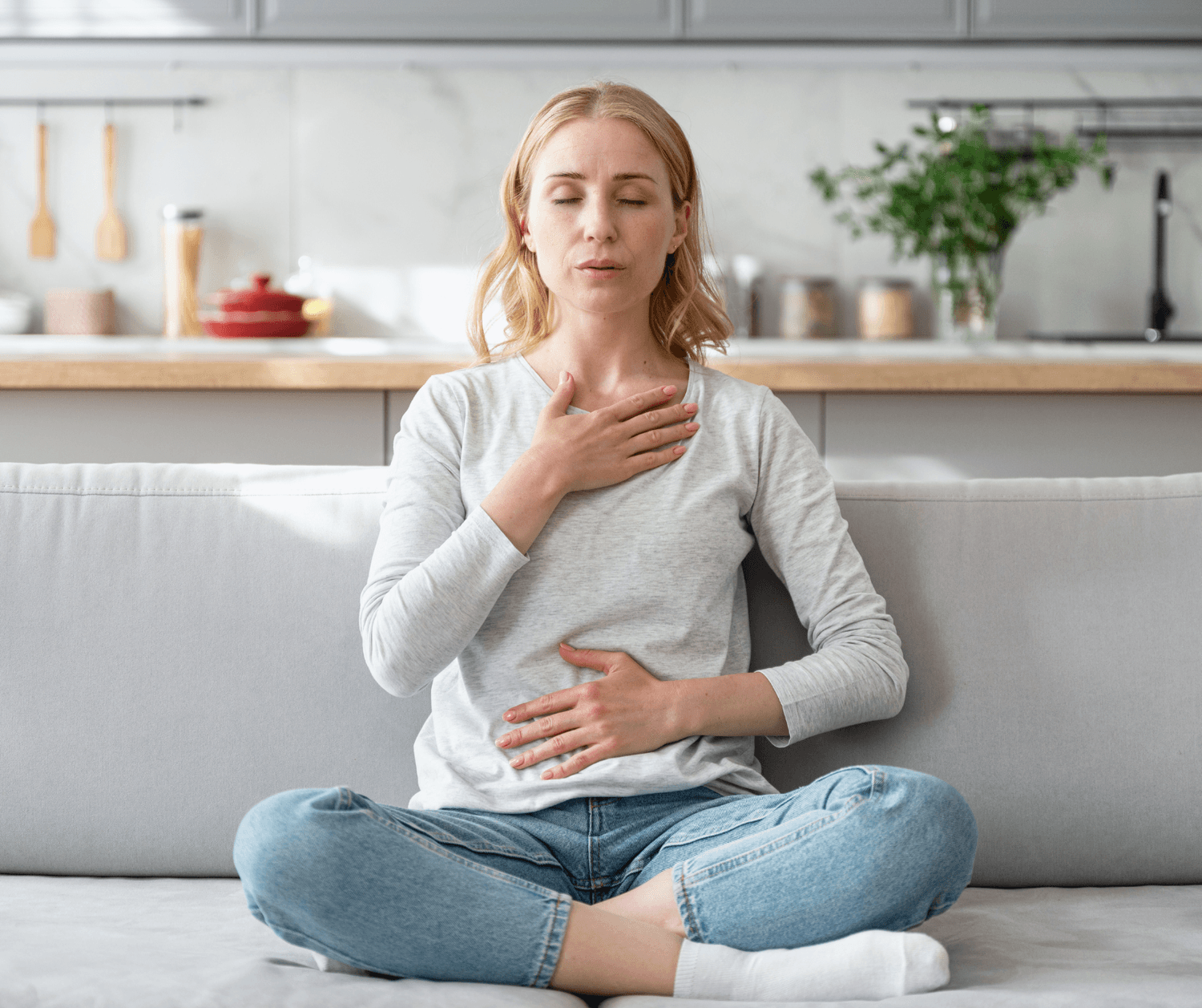 a woman sitting in the living room and meditating