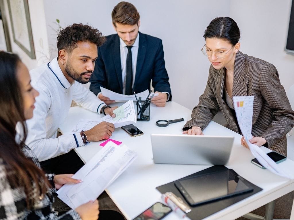 A group of four professionals representing funders and commissioners who use the Lead With Impact platform to track social value across their portfolio