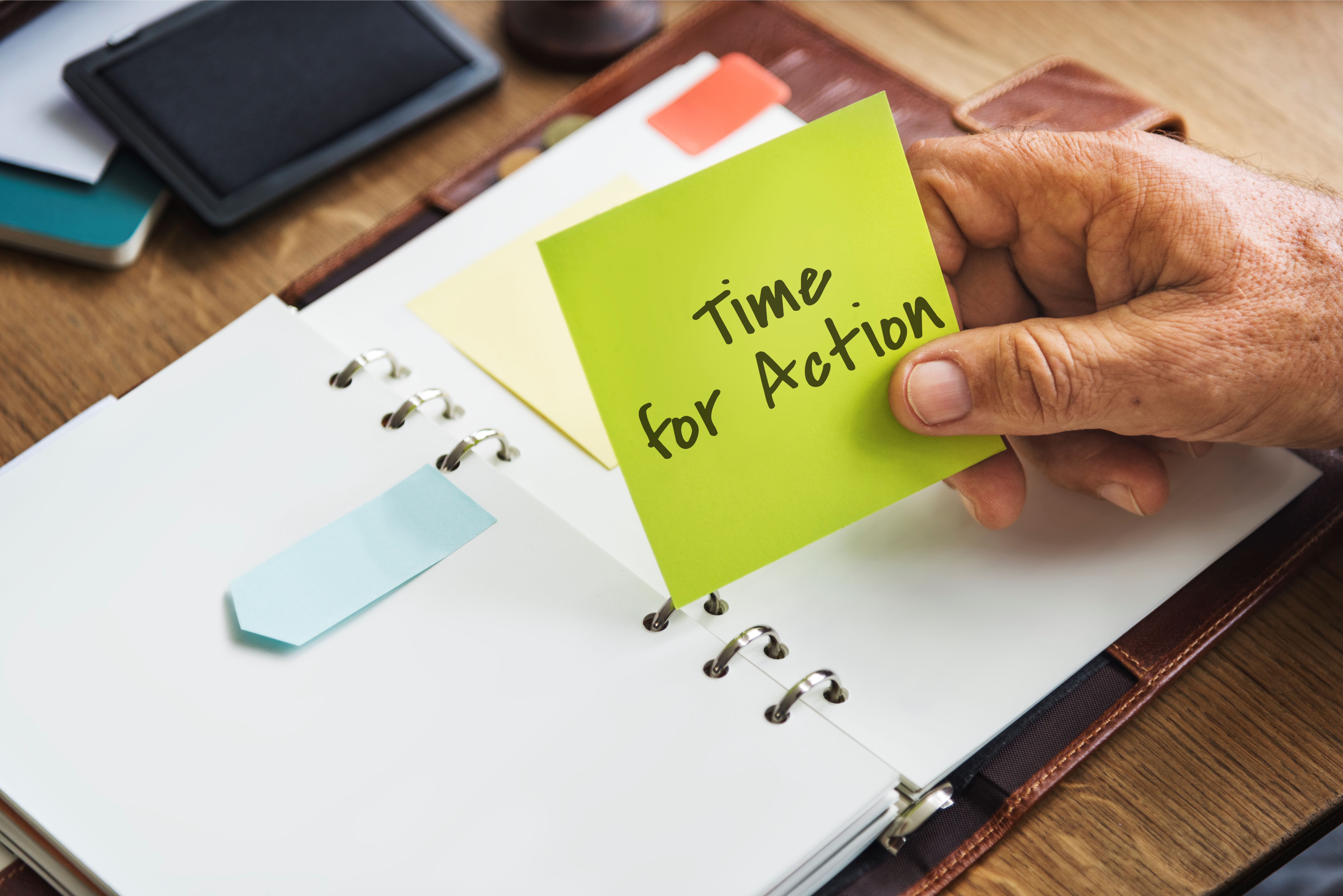 a-man-holding-a-memo-of-time-for-action