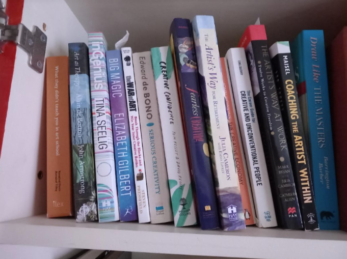 A shelf full of books on creativity