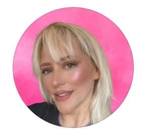 Aimee Cole smiling against a pink background