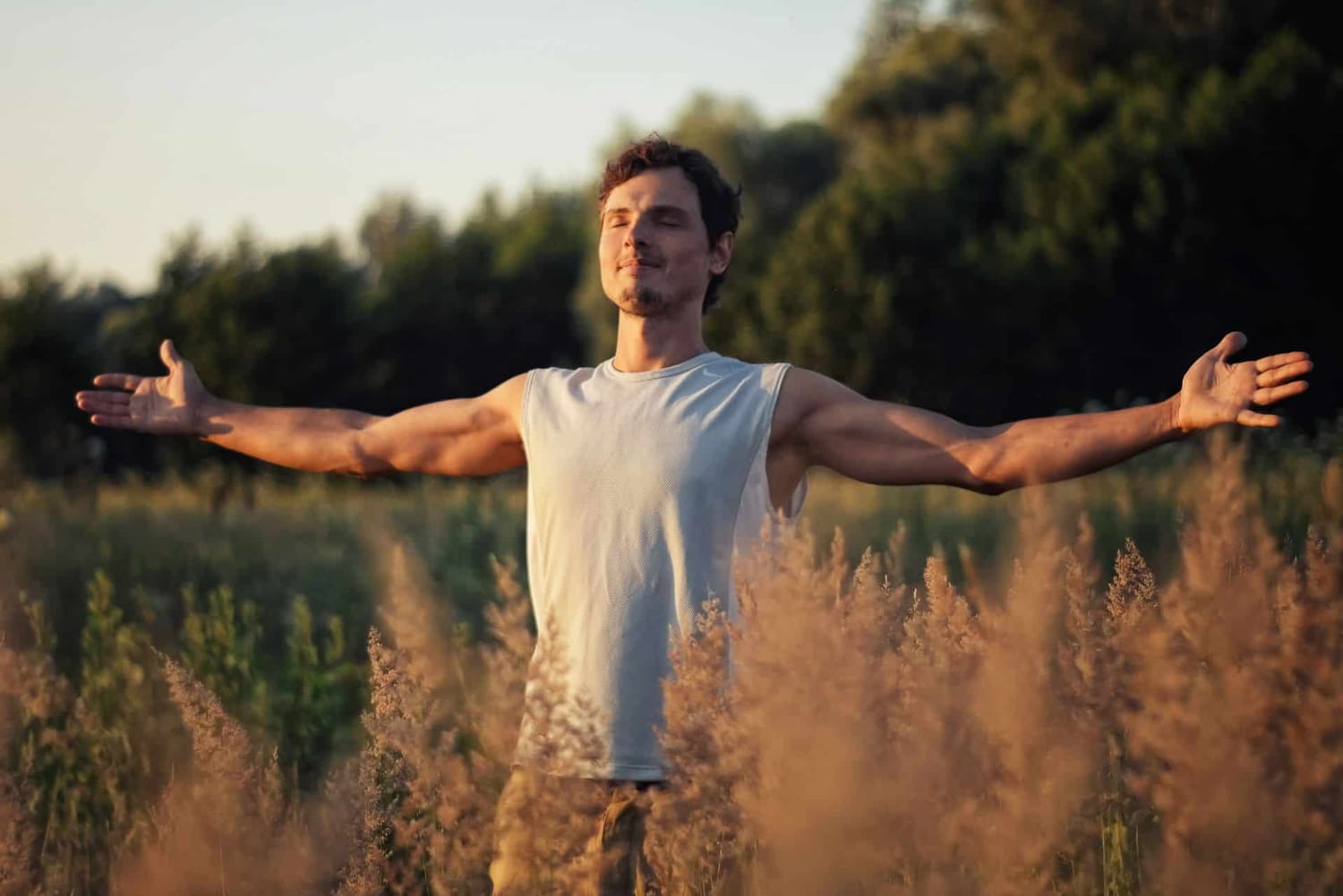 Man breathing freely outdoors, embracing vibrant health and holistic wellbeing.