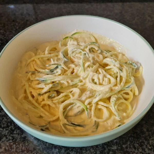 Raw zucchini noodles in a creamy sauce, a Raw Reset meal example