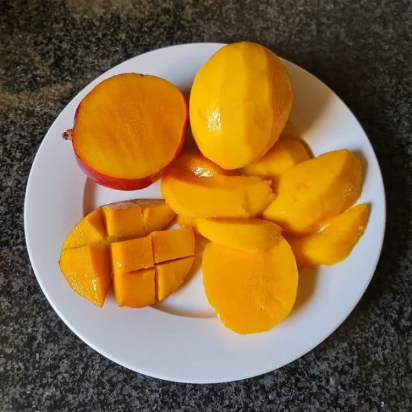 Sliced fresh mango served as part of a raw detox meal