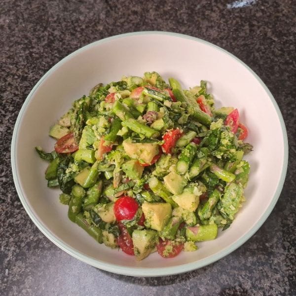 Fresh asparagus, tomato and avocado salad supporting raw food detox