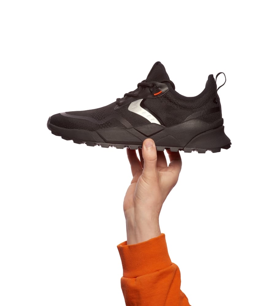 Hand Holding Black Sneakers