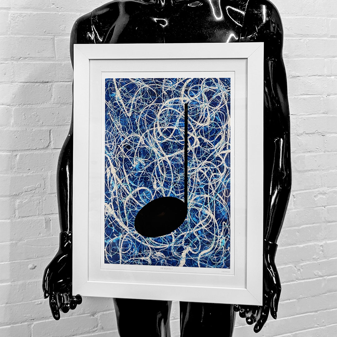black mannequin holding a framed giclée print of a blue music graffiti painting