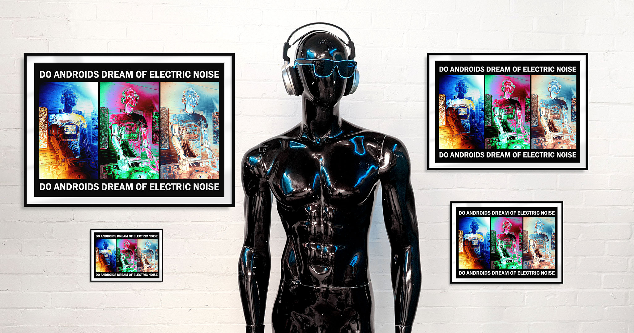 Black mannequin with headphones and sunglasses standing in front of a white wall with four framed art prints in different sizes
