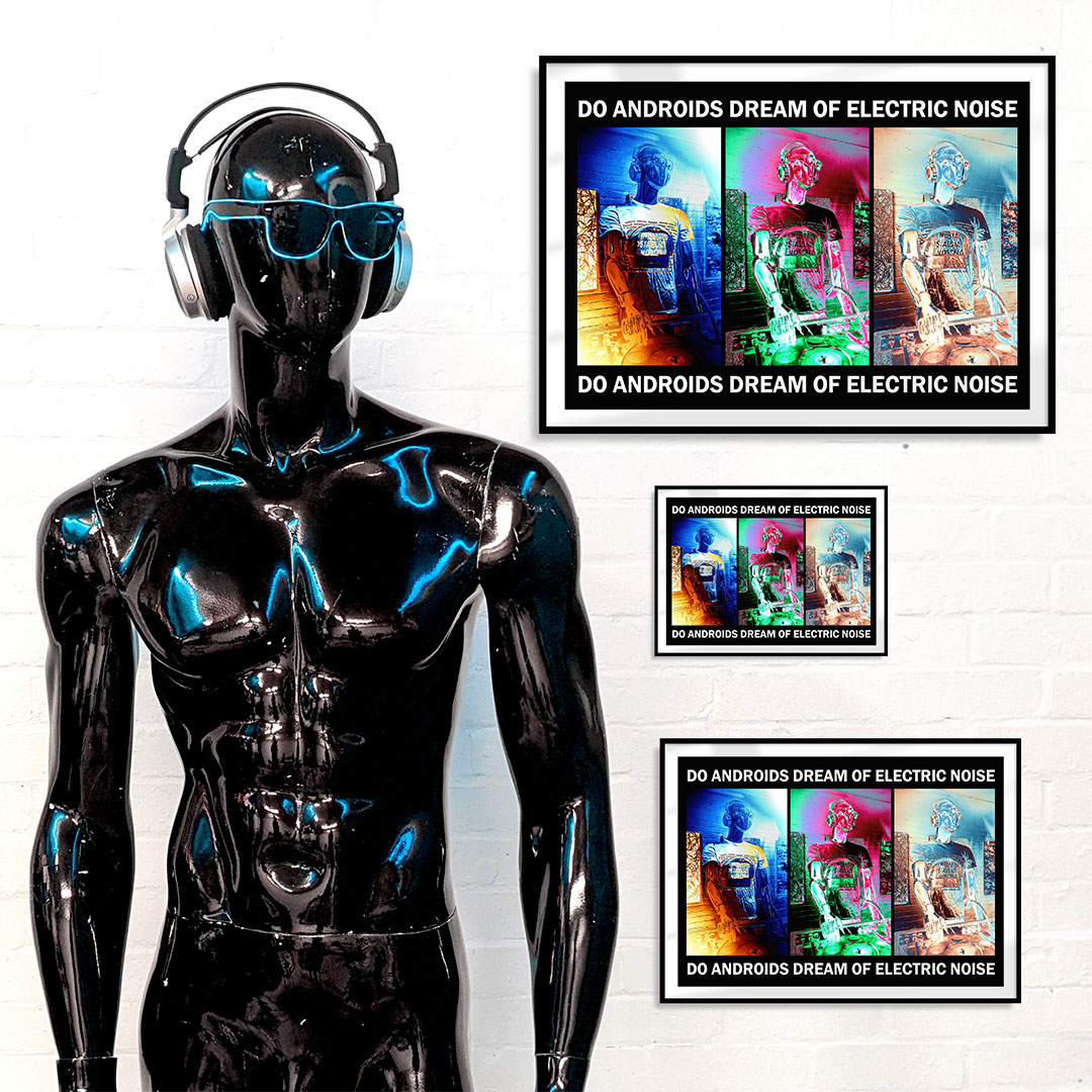 Black mannequin with headphones and sunglasses standing in front of a white wall with four framed art prints in different sizes