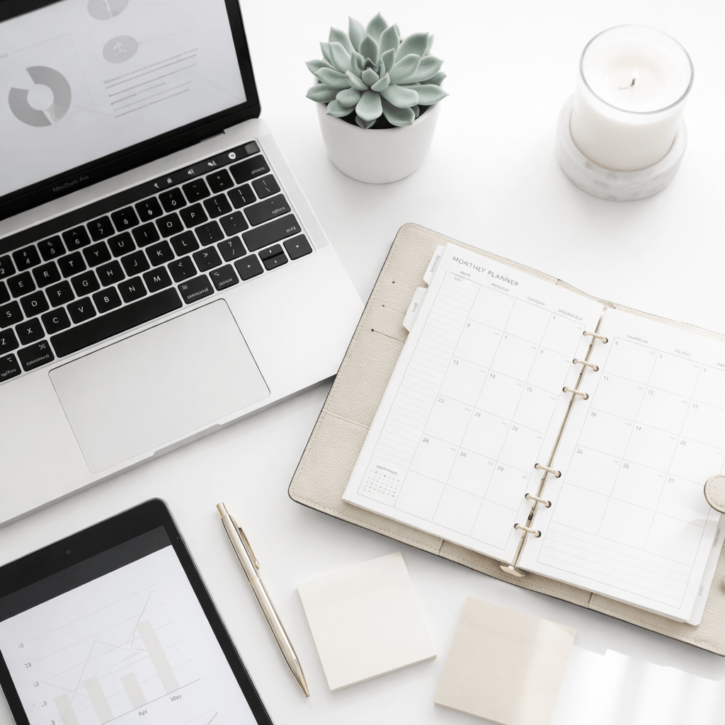 Laptop with coffee and smartphone on a desk, representing remote work and productivity.
