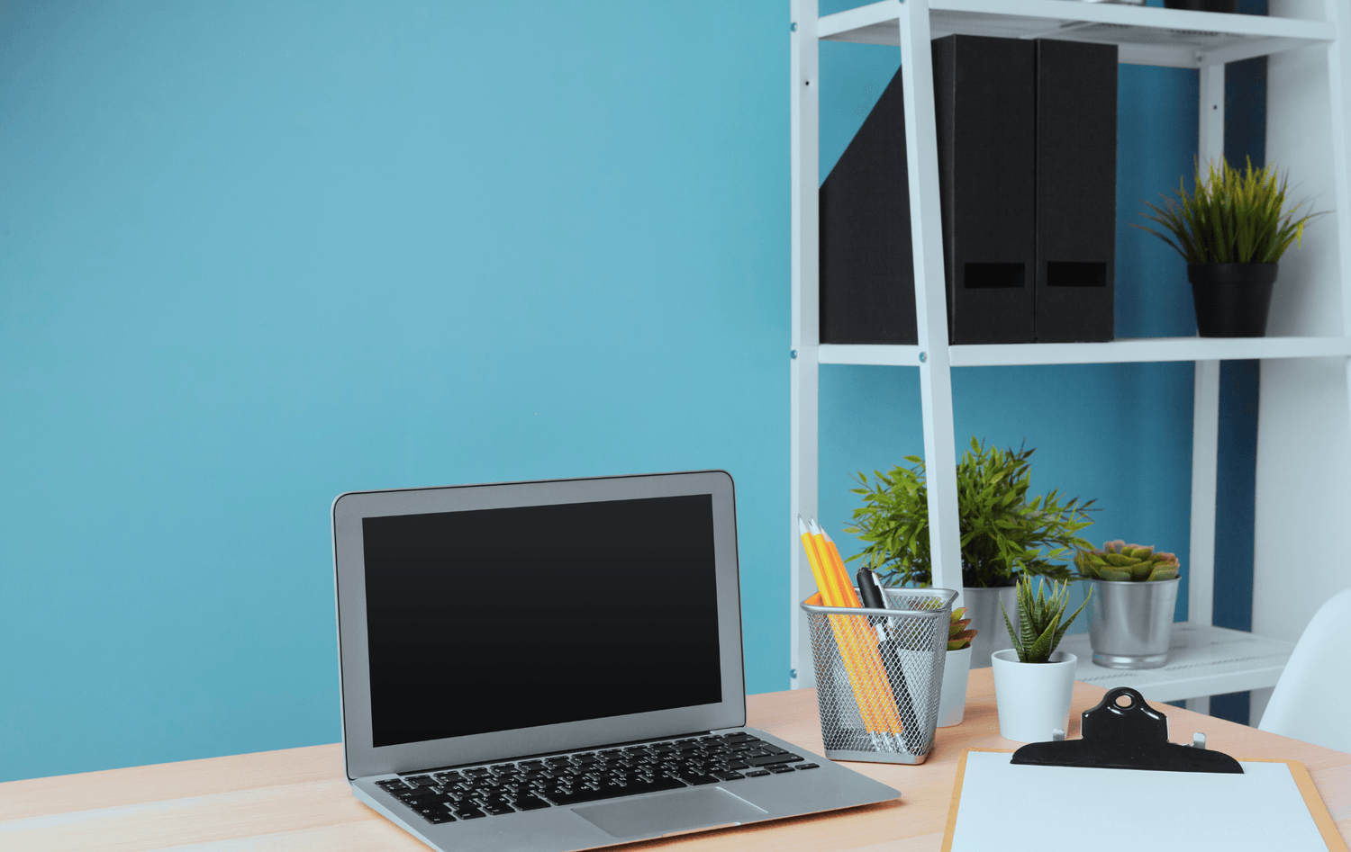 “Clean organized workspace with laptop and shelves representing calm digital business systems.