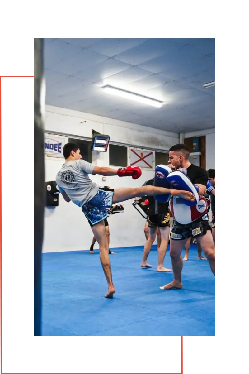 Mo Khalifa training in the gym kicking the pads