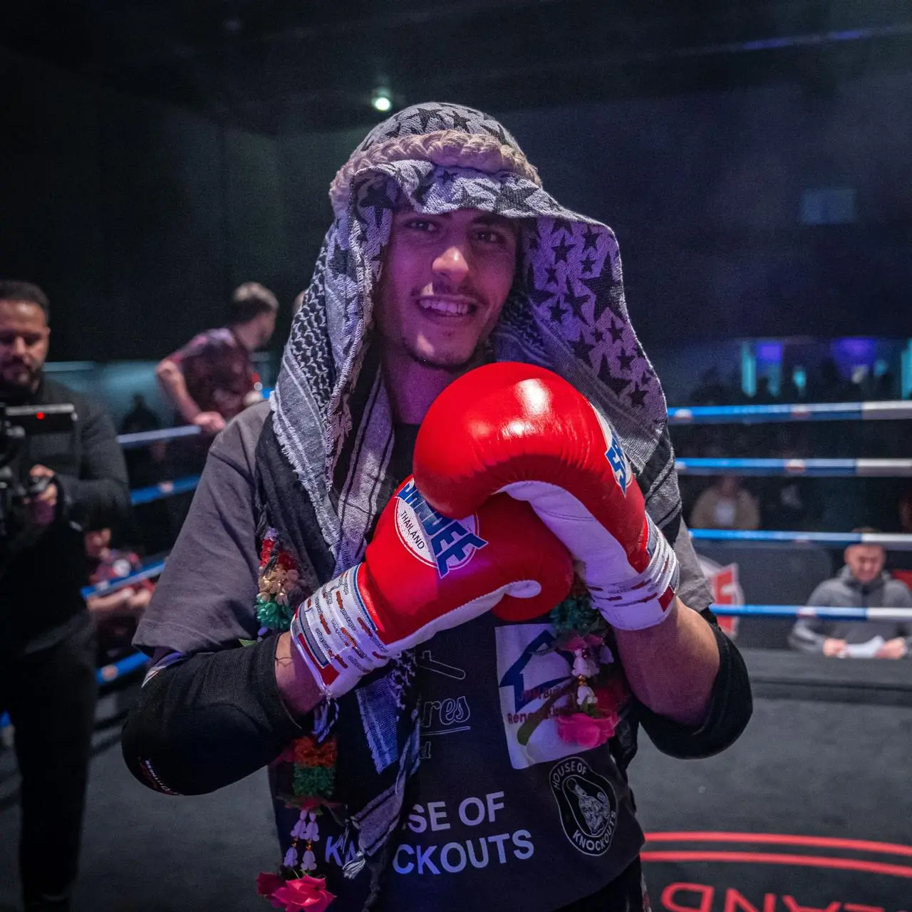 Mo Khalifa smiling at the camera in a boxing ring, before the bell goes and the fight starts