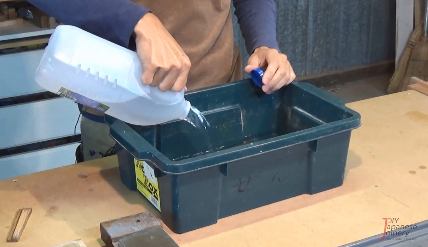 Tray being filled with water to soak sharpening stones