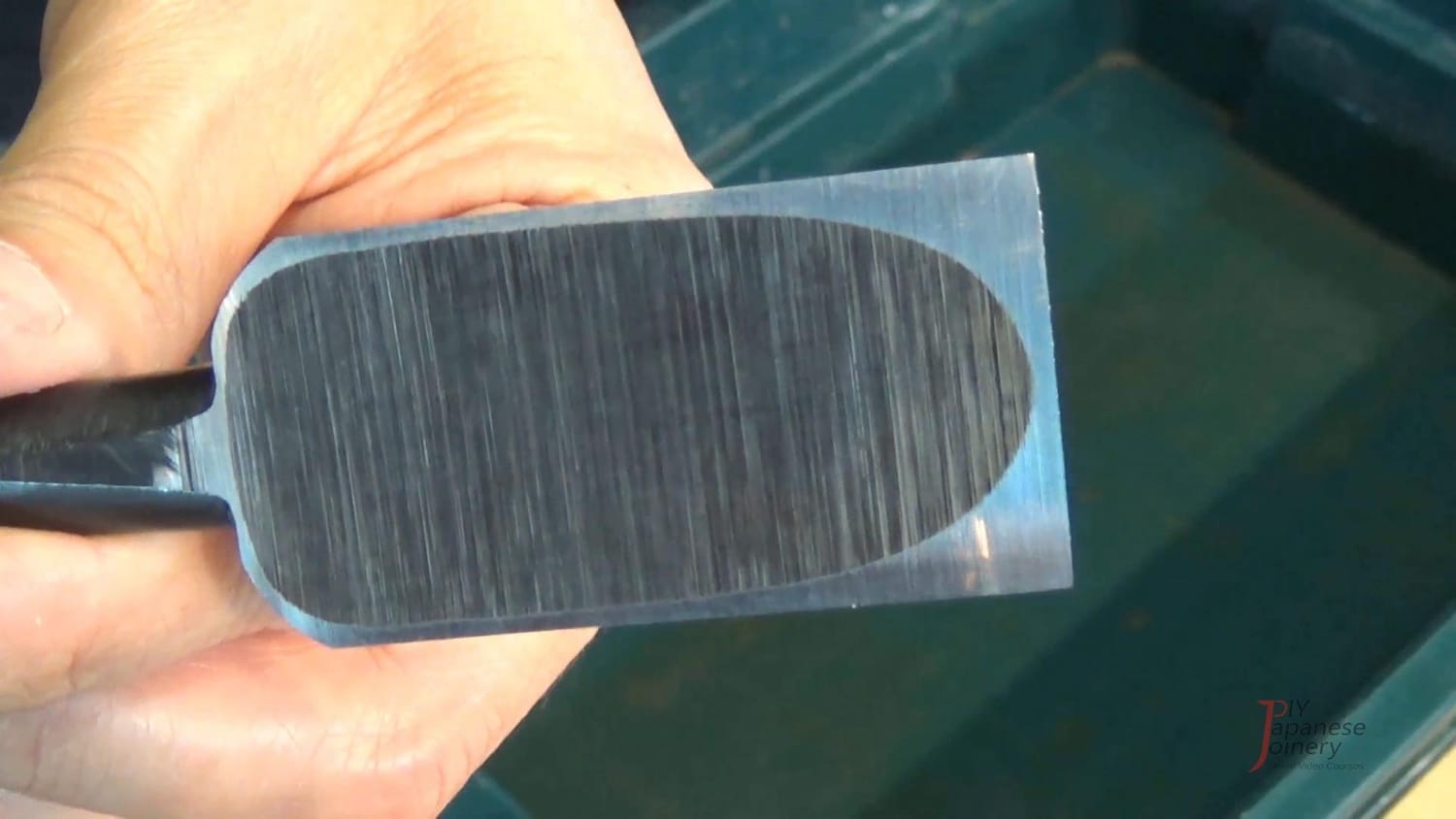 Close-up photo of a chisel backside with visible scratches from a diamond stone (before polishing).
