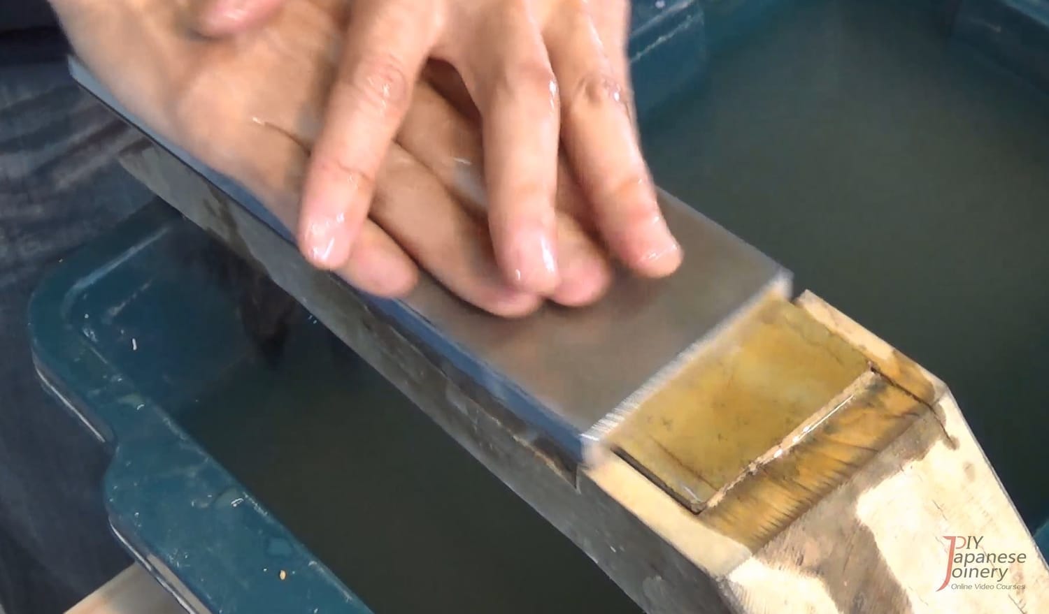 A finishing stone being resurfaced with a flattening plate