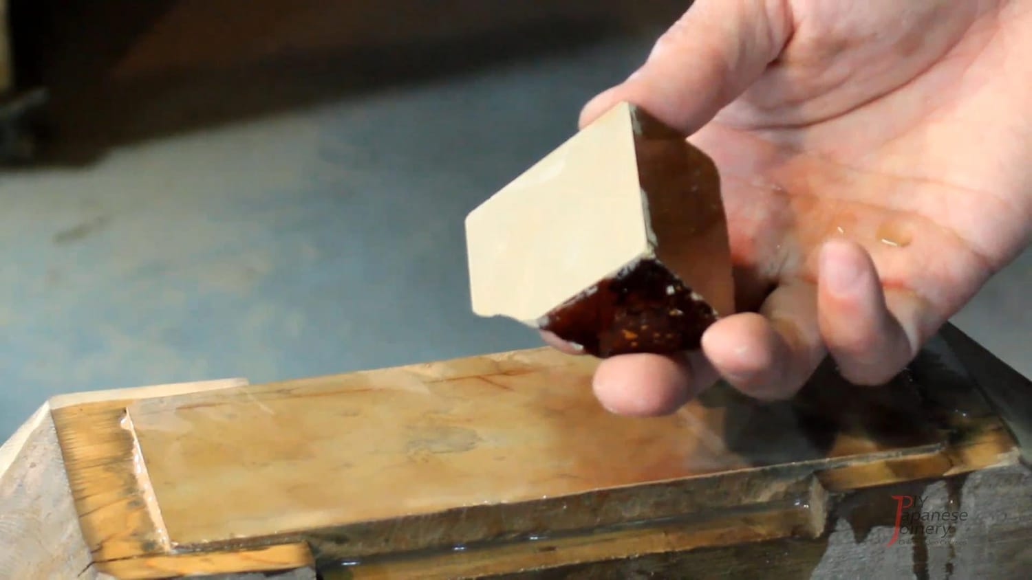 Nagura stone displayed against a finishing stone to illustrate the polishing process.