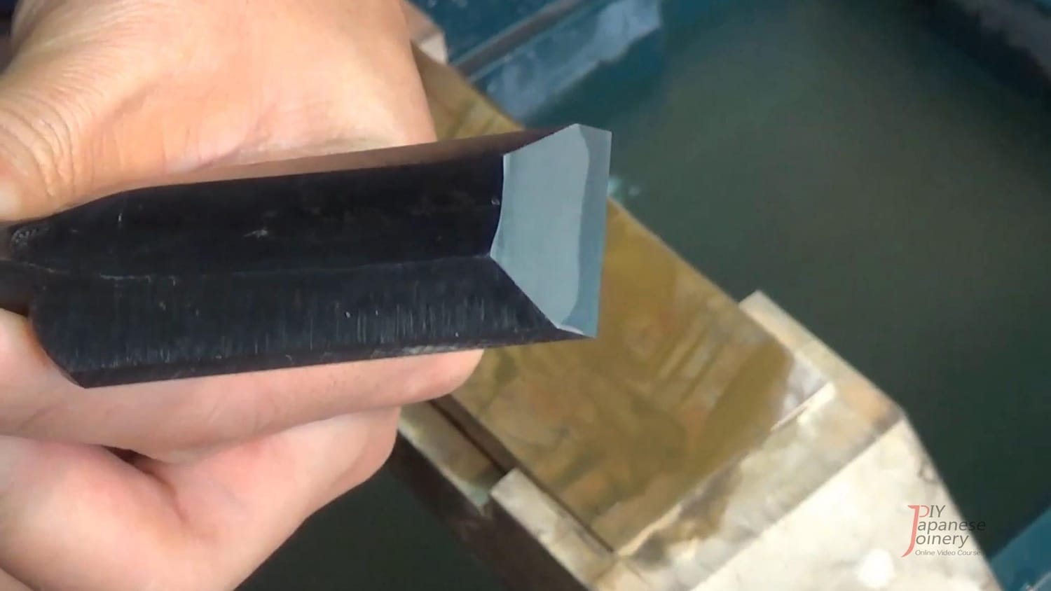 A sharpened Japanese chisel with the bevel polished flat and smooth, free of any uneven surface.