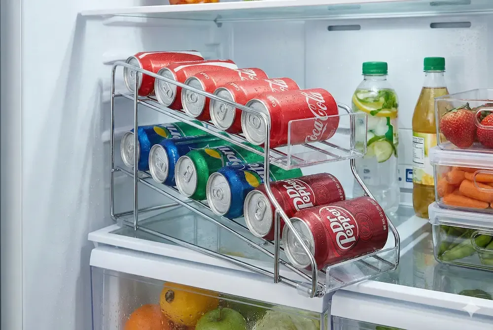 Gravity feed soda can dispenser for fridge organization.