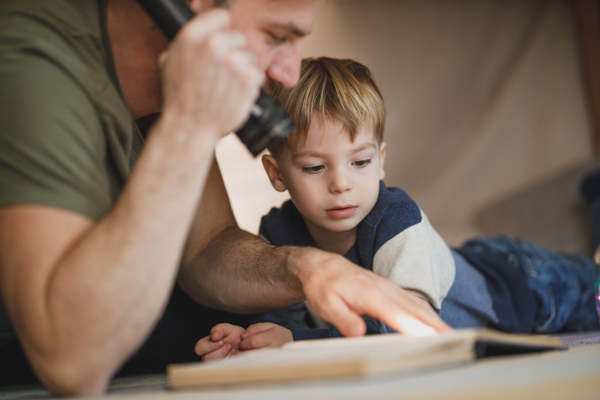 Toddler and Baby Fighting Bedtime Guide - Dad reads book to son