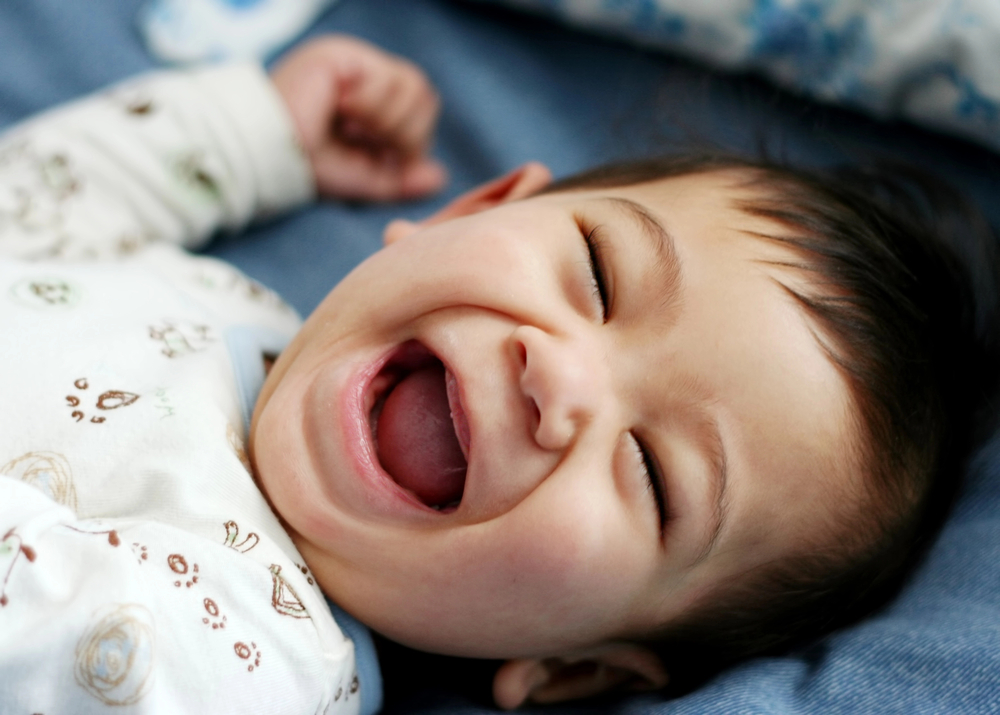 Baby-Led Sleep with Twins Guide - Twins laying on blanket drinking milk from bottles