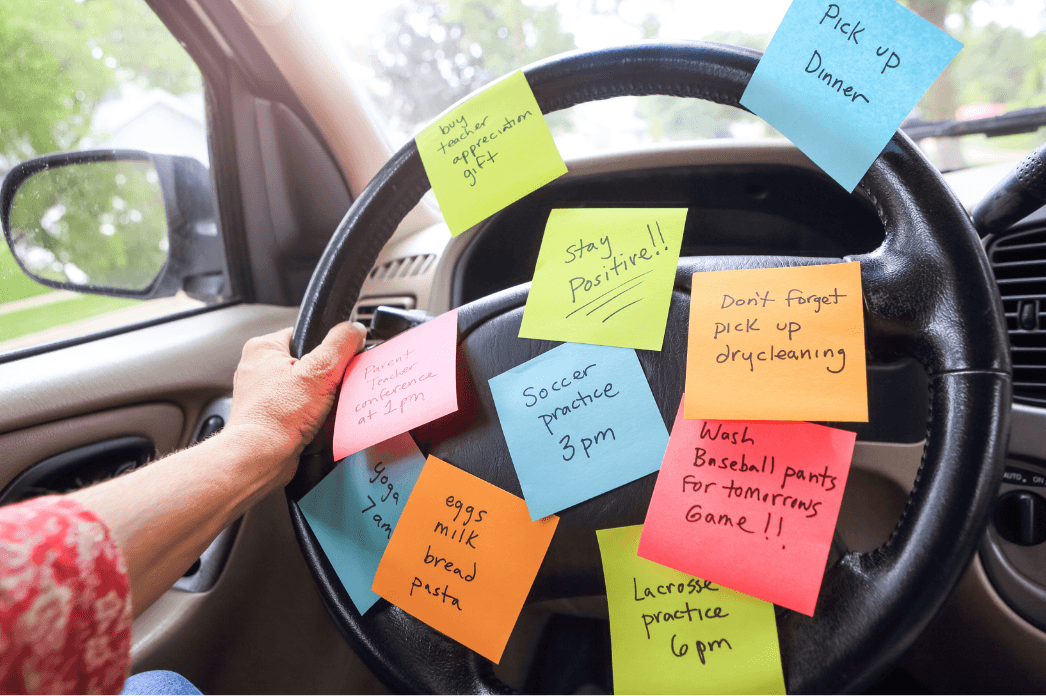 Car steering wheel filled with to-do sticky notes
